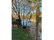Serene lake view from the property showcasing a private dock and lush, mature landscaping at 377 Riverwood Rd, Mooresville, NC 28117