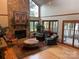 Inviting living room boasting a stone fireplace, hardwood floors, and access to an outdoor patio area at 377 Riverwood Rd, Mooresville, NC 28117