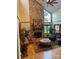 Spacious living room featuring a stone fireplace, hardwood floors, and large windows offering ample natural light at 377 Riverwood Rd, Mooresville, NC 28117