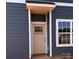 Exterior shot of a home's entrance with blue siding and a covered doorway at 4049 Port Richmond Ave # 11, Gastonia, NC 28056