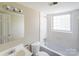 This well-lit bathroom has a sink, toilet, tub, and bright window at 349 Dublin Ct, Gastonia, NC 28054