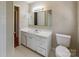 Bathroom features a white vanity, mirror, standard toilet and tile flooring at 349 Dublin Ct, Gastonia, NC 28054