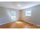 Bright bedroom features hardwood floors and natural light from two large windows at 349 Dublin Ct, Gastonia, NC 28054