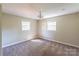 A well-lit bedroom with neutral walls, carpet flooring, and natural light from two windows at 349 Dublin Ct, Gastonia, NC 28054