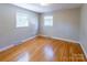 This bedroom features hardwood floors and natural light from two windows at 349 Dublin Ct, Gastonia, NC 28054