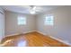 Comfortable bedroom featuring hardwood floors, a ceiling fan, and natural light from two windows at 349 Dublin Ct, Gastonia, NC 28054