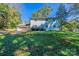 View of the backyard, garage, and exterior features of a house in a leafy setting at 349 Dublin Ct, Gastonia, NC 28054