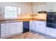 This functional kitchen features white cabinets, black appliances, and good natural light at 349 Dublin Ct, Gastonia, NC 28054