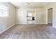 Neutral living room with a view into the kitchen with white cabinets and black appliances at 349 Dublin Ct, Gastonia, NC 28054