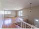 This is a light-filled living room with hardwood floors, many windows and a staircase at 349 Dublin Ct, Gastonia, NC 28054