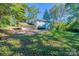 Backyard view with a two-car garage and mature trees providing shade and privacy at 349 Dublin Ct, Gastonia, NC 28054