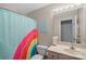 Bright bathroom with rainbow shower curtain and vanity at 357 China Grove Rd, Kannapolis, NC 28083