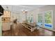 Bright dining area with wooden table and bench, looking toward kitchen and pool at 357 China Grove Rd, Kannapolis, NC 28083