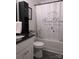 Well-lit bathroom featuring granite counters, a stylish shower curtain, and a modern black storage cabinet at 4986 6Th Sw St, Catawba, NC 28609