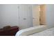 Neutral bedroom featuring double closets, soft bedding, and a wooden storage chest at 4986 6Th Sw St, Catawba, NC 28609