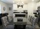 A dining area with tufted chairs and a black table sits adjacent to the updated kitchen at 4986 6Th Sw St, Catawba, NC 28609