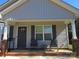 Covered front porch featuring two chairs, a small table, brick accents and gray siding at 4986 6Th Sw St, Catawba, NC 28609