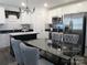 Bright kitchen featuring white cabinetry, stainless steel appliances, and a black dining table at 4986 6Th Sw St, Catawba, NC 28609