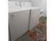 Functional laundry room with modern washer and dryer units and a colorful rug at 4986 6Th Sw St, Catawba, NC 28609