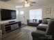 Cozy living room with gray furniture, wood-look flooring, and ample natural light at 4986 6Th Sw St, Catawba, NC 28609