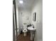 Renovated bathroom showcases new white subway tiles, modern black fixtures, and a pedestal sink at 7608 Kershaw Camden Hwy, Kershaw, SC 29067