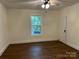 An empty bedroom with hardwood floors and window to backyard at 7608 Kershaw Camden Hwy, Kershaw, SC 29067