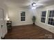 Bedroom featuring wood floors, a window, a ceiling fan, and a side table at 7608 Kershaw Camden Hwy, Kershaw, SC 29067