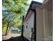 A glimpse of a home's exterior featuring white siding, a black rain gutter, and a brick chimney at 7608 Kershaw Camden Hwy, Kershaw, SC 29067