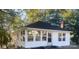 Charming white cottage with a sunroom and updated roof at 7608 Kershaw Camden Hwy, Kershaw, SC 29067