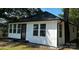Charming house featuring modern design elements, including white siding and black trim at 7608 Kershaw Camden Hwy, Kershaw, SC 29067