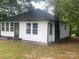 Exterior angle of home with black trim and white siding at 7608 Kershaw Camden Hwy, Kershaw, SC 29067