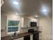 The kitchen includes white cabinets, black appliances and subway tile backsplash at 7608 Kershaw Camden Hwy, Kershaw, SC 29067