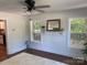 Bright living room with refinished hardwood floors, and a white mantle, and views into the kitchen at 7608 Kershaw Camden Hwy, Kershaw, SC 29067