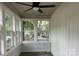 Bright sunroom with white trim windows and a ceiling fan at 7608 Kershaw Camden Hwy, Kershaw, SC 29067