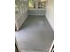 Sunroom with epoxy flooring, white walls, and multiple windows at 7608 Kershaw Camden Hwy, Kershaw, SC 29067