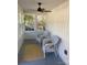 Bright sunroom featuring white wicker furniture, a yellow rug, and plenty of natural light at 7608 Kershaw Camden Hwy, Kershaw, SC 29067