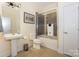 Modern bathroom with grey tile, tub/shower combo, and pedestal sink at 929 Westmere Ave, Charlotte, NC 28208