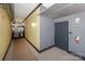 Modern hallway with grey and yellow walls, carpet, and a fire extinguisher at 929 Westmere Ave, Charlotte, NC 28208