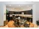 Modern kitchen with dark cabinetry, granite counters, and breakfast bar at 929 Westmere Ave, Charlotte, NC 28208