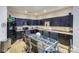 Modern kitchen with dark cabinetry, granite counters, and breakfast bar at 929 Westmere Ave, Charlotte, NC 28208