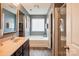 Modern bathroom featuring a soaking tub, walk-in shower, and stylish vanity with marble counters at 1176 Whitehall Hill Rd, York, SC 29745