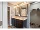 Elegant bathroom features dual sinks, dark cabinetry, and a well-organized walk-in closet at 1176 Whitehall Hill Rd, York, SC 29745