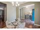 Bright dining room featuring modern white chairs, a glass-top table, and elegant chandelier at 1176 Whitehall Hill Rd, York, SC 29745