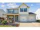 Charming two-story home features a two car garage, blue shutters and vinyl siding at 1176 Whitehall Hill Rd, York, SC 29745