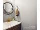 Stylish powder room with modern vanity, geometric mirror, and unique brass faucet at 1176 Whitehall Hill Rd, York, SC 29745