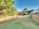 Landscaped backyard with wooden fence and open space at 124 Kendrick Farm Dr, Mount Holly, NC 28120