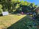 Backyard featuring a grassy yard, with a firepit and surrounding trees at 3337 Eastway Dr, Charlotte, NC 28205