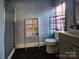 Practical bathroom with a shower, toilet, and shelving unit at 3337 Eastway Dr, Charlotte, NC 28205