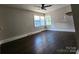 Comfortable bedroom with hardwood floors, a ceiling fan, and a bright window at 3337 Eastway Dr, Charlotte, NC 28205