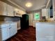 Well-lit kitchen features white cabinets, modern appliances, and hardwood floors at 3337 Eastway Dr, Charlotte, NC 28205